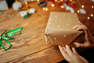 High angle view of hand holding christmas paper