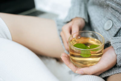 Midsection of woman holding drink