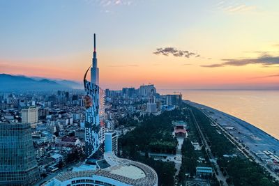 High angle view of buildings in city during sunset