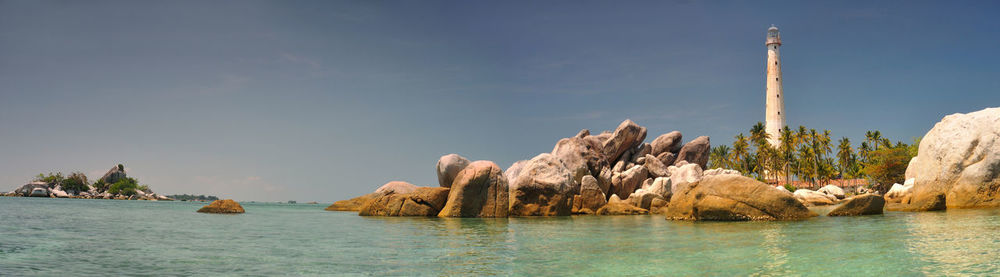 Panoramic view of rocks in sea against sky