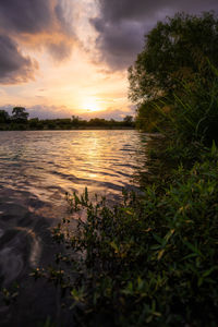 Scenic view of lake against sky during sunset
