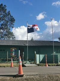 Road signal against sky in city