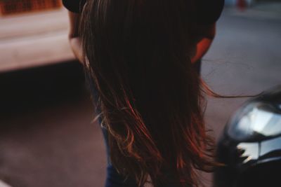 Midsection of woman with long hair standing on road