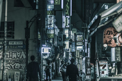 People walking on street at night