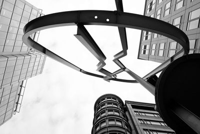 Low angle view of metal sculpture and buildings at liverpool street