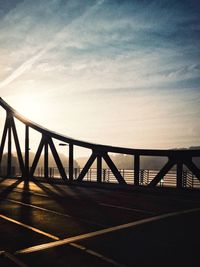 Silhouette bridge against sky at sunset