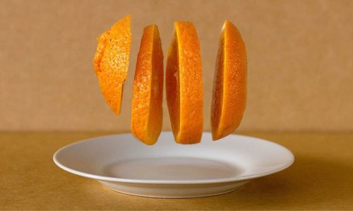 Close-up of orange slice in plate