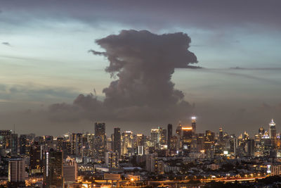 Illuminated buildings in city against sky at night