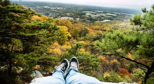 Low section of woman standing on landscape