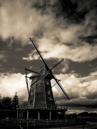 Low angle view of windmill against cloudy sky