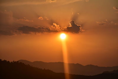 Scenic view of silhouette mountains against sky during sunset