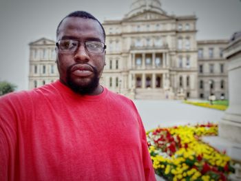 Portrait of serious man with government building in background