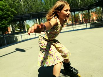 Playful girl inline skating at park