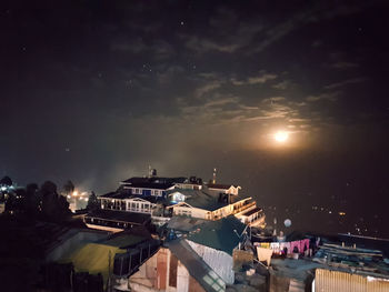 Illuminated city against sky at night