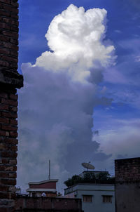 Low angle view of building against cloudy sky