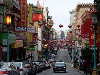 Cars parked on street amidst buildings at chinatown