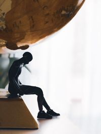 Low section of man statue on table
