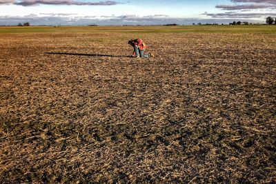 Full length of boy running on grassy field