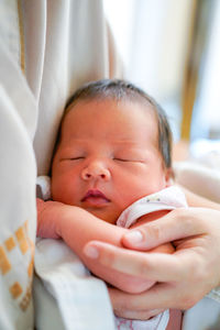 Midsection of baby boy lying on bed at home