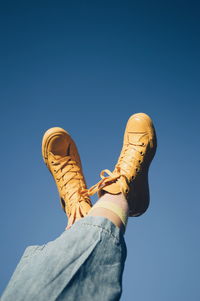 Low section of man against clear blue sky