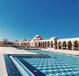 View of swimming pool against clear blue sky