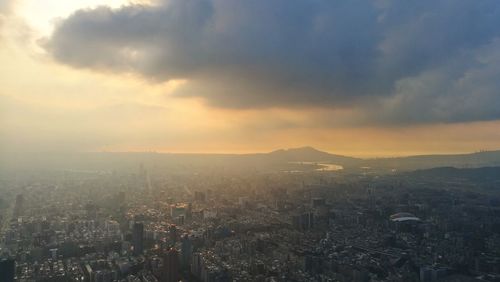 Aerial view of cityscape against sky during sunset