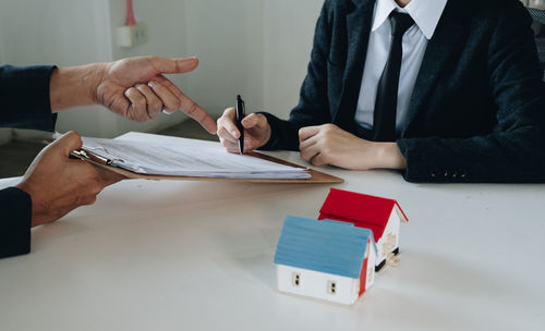 Midsection of businessman working at office