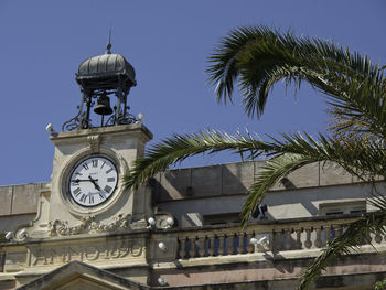 Low angle view of clock tower against sky