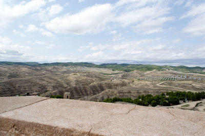 Scenic view of landscape by sea against sky