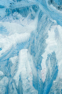 Winter frosty patterns on glass. christmas festive background. ice crystals on window. 