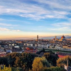 Aerial view of duomo santa maria del fiore amidst cityscape against cloudy sky