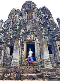 Full length of senior man outside temple against building