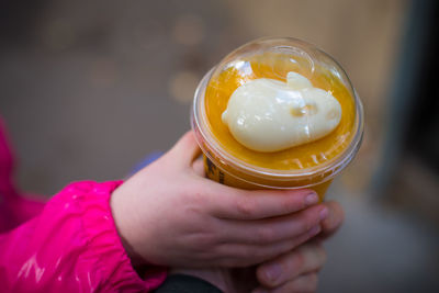 Close-up of hand holding ice cream