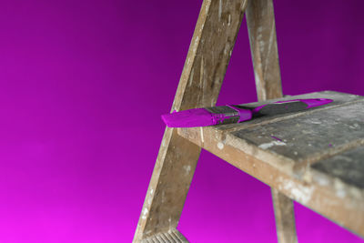 Low angle view of multi colored pencils on table against blue background