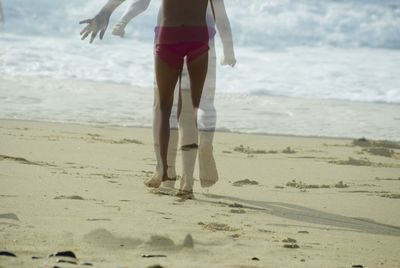 Blurred motion of woman running at sandy beach