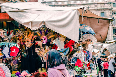 Tourist looking at a stand with masks