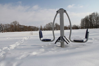 Snow covered field against sky