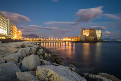 Bridge over river against sky at night napoli castel dell'ovo