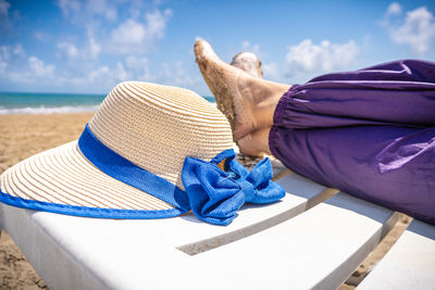 Low section of woman wearing hat