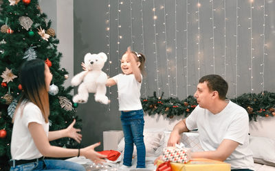 Side view of woman with dog at home