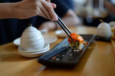 Close-up of person preparing food on table