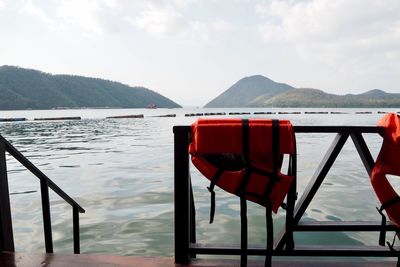 Scenic view of lake against sky with safety shirt