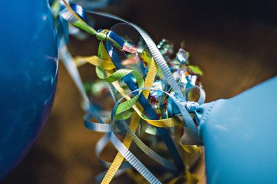 Close-up of cropped balloons with colorful strings