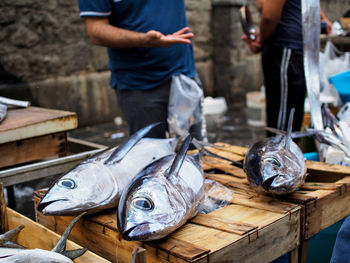 High angle view of fishes on wooden crate at market