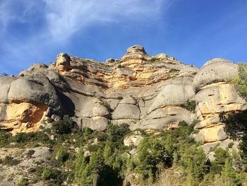Low angle view of rock formation against sky