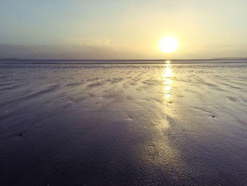 View of calm beach at sunset