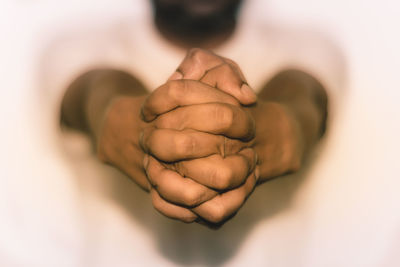 Close-up of man with hands clasped