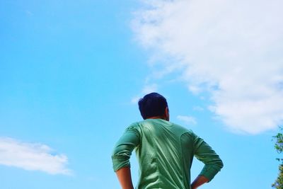 Rear view of man standing against sky