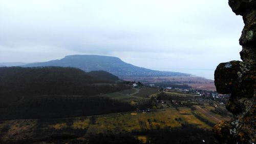 Scenic view of mountains against cloudy sky