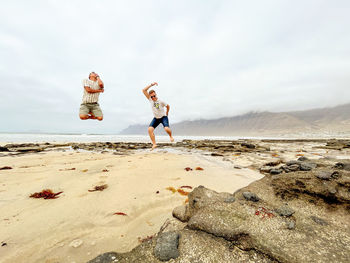  view of men jumping on beach